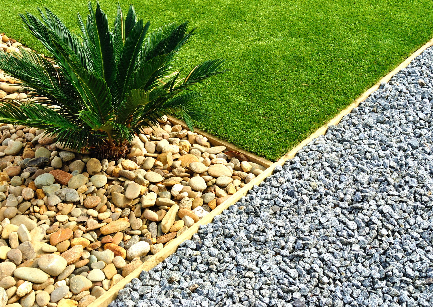 Aménagement de jardin avec graviers, galets décoratifs et bordure de pelouse